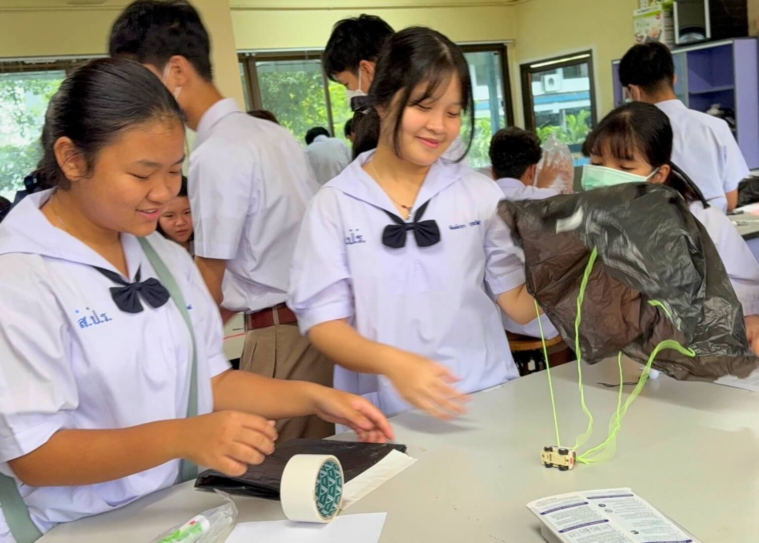 SPR BFITS Program students working together to build a parachute as part of a STEM Project